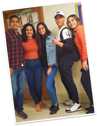 a group of students pose in school hallway